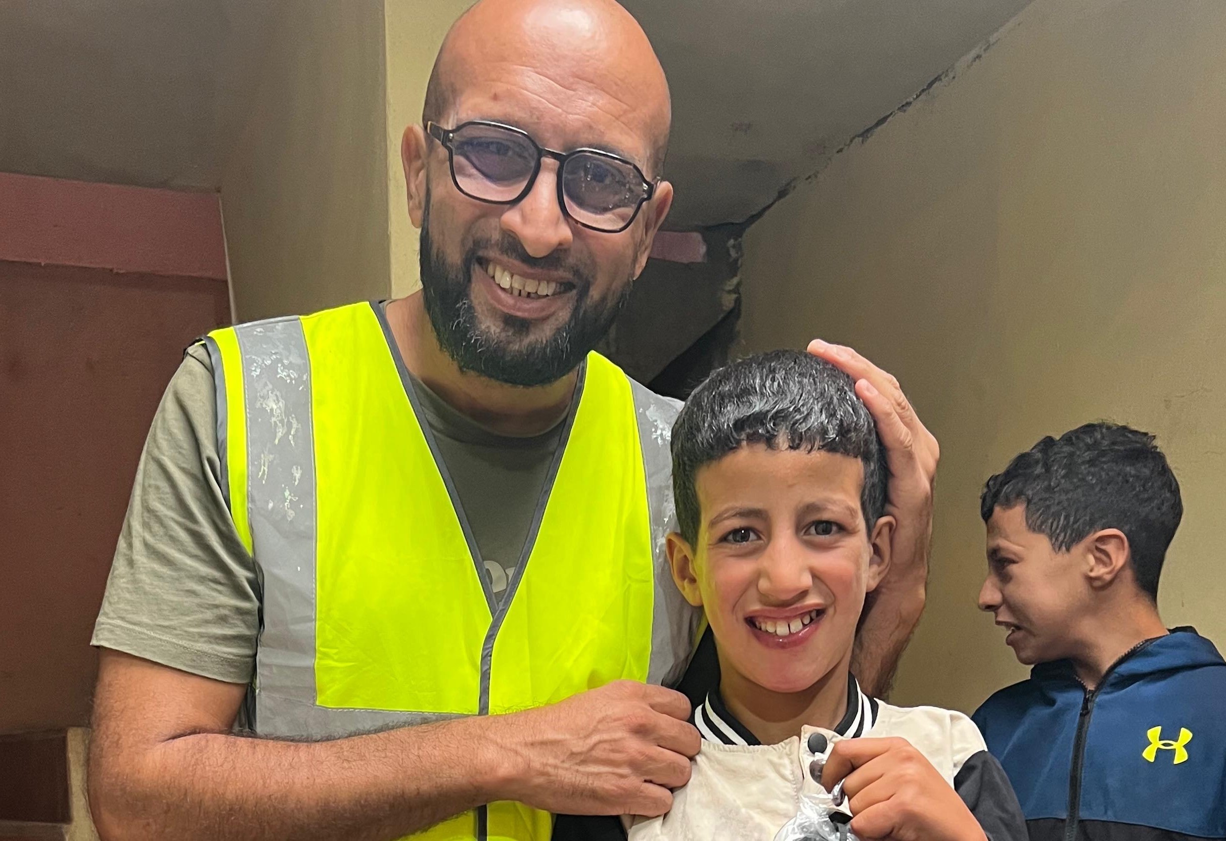 Volunteer distributing essential supplies to community members, demonstrating practical support and care